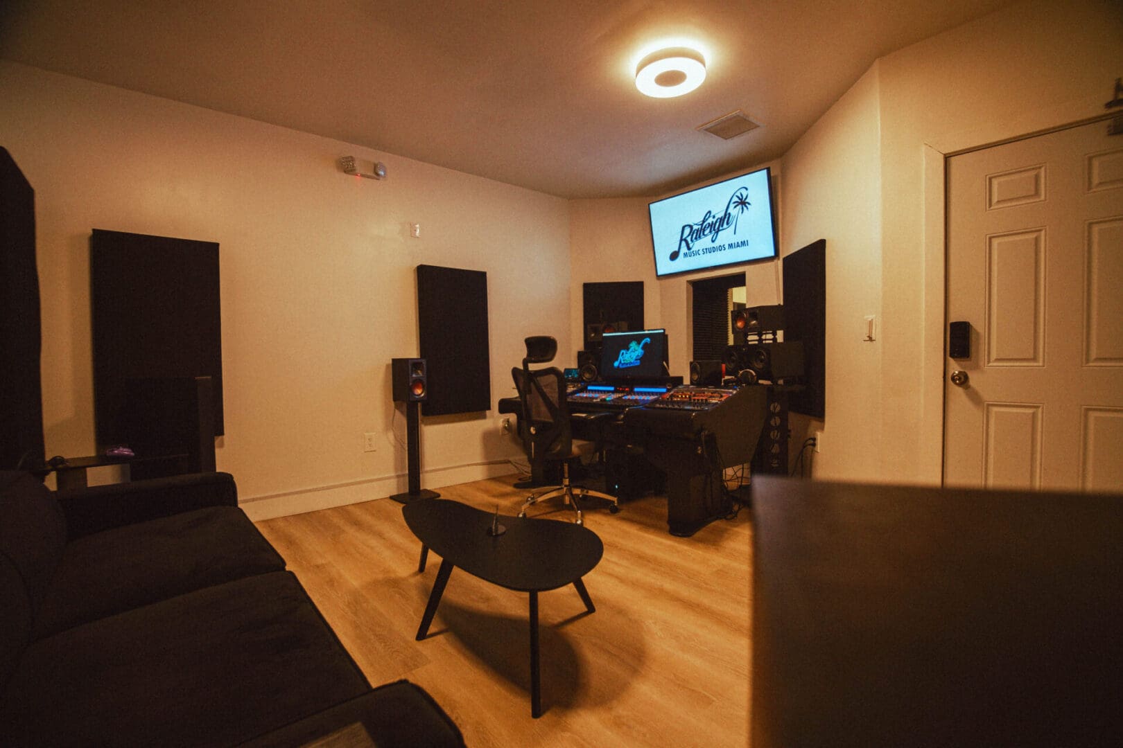 A room with a large screen and many speakers