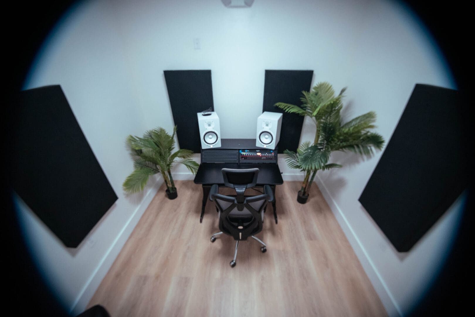 A room with two speakers and a desk