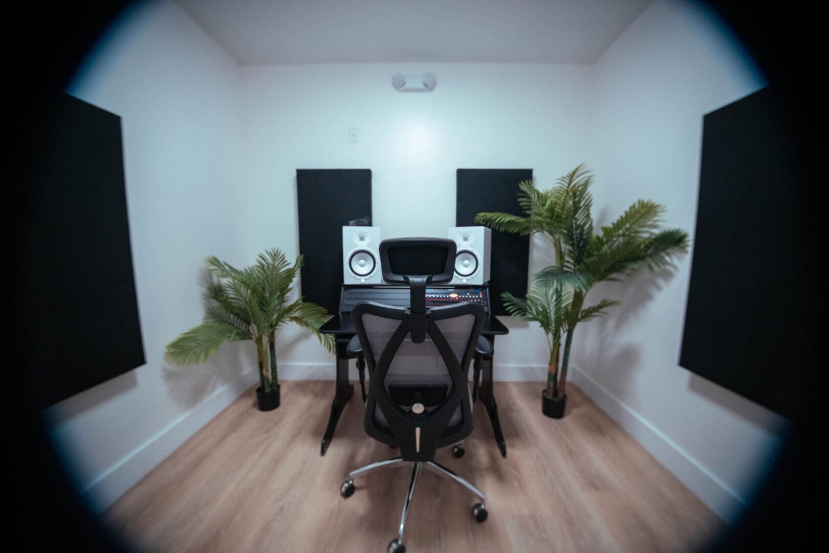 A room with two speakers and a desk