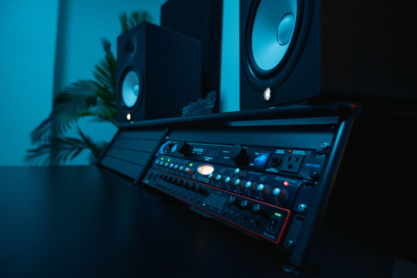 A black table with some speakers and a sound board