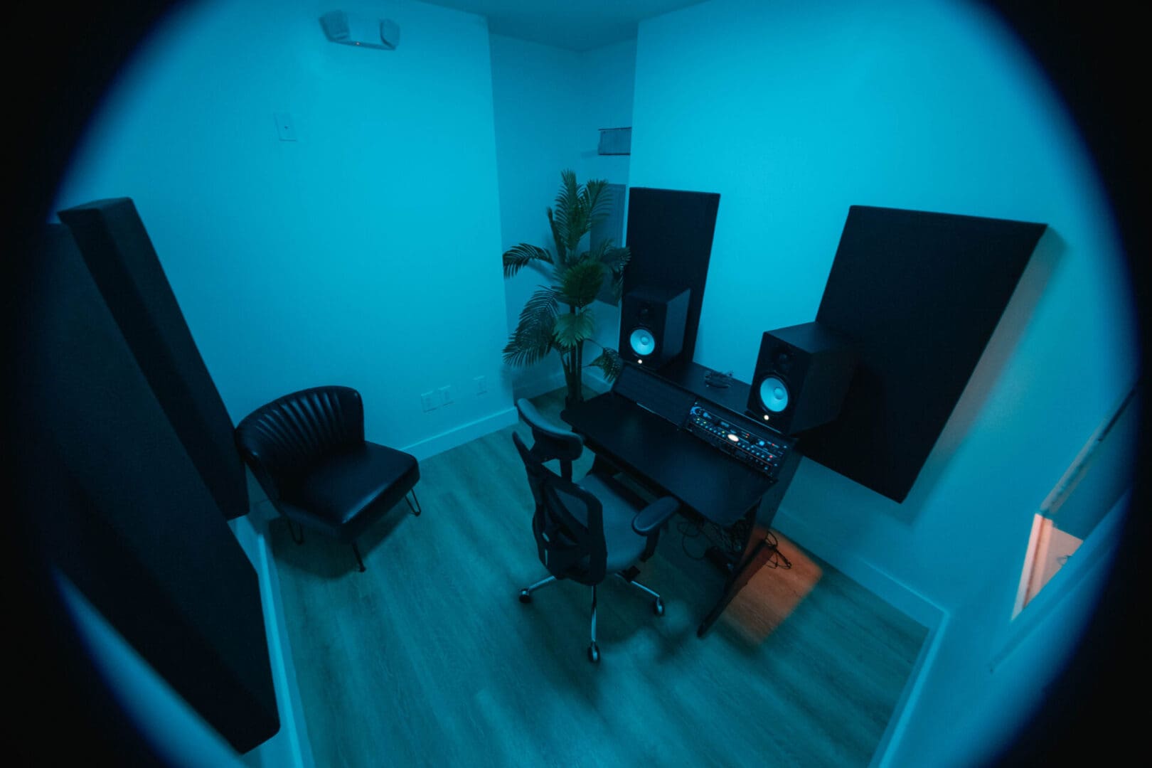 A room with two speakers and a desk