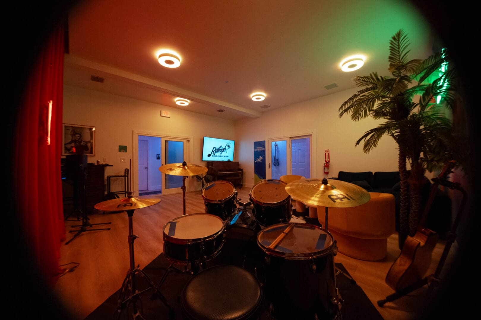 A room with many drums and a large screen