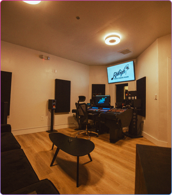 Purple-lit music studio with mixing console.